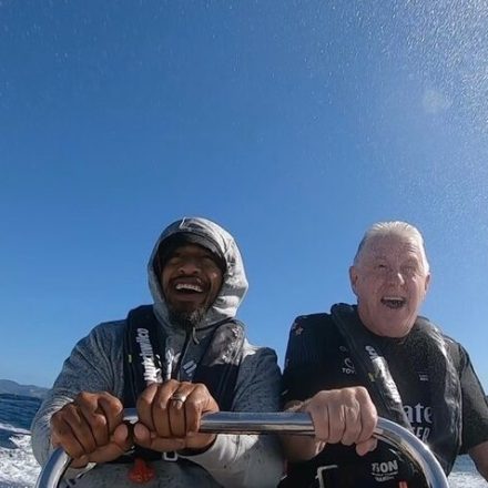 a man sitting on top of a snow covered mountain