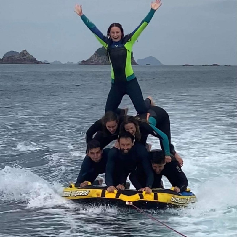 a group of people riding skis on a body of water