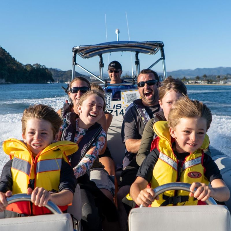 a man sitting in a boat on a body of water